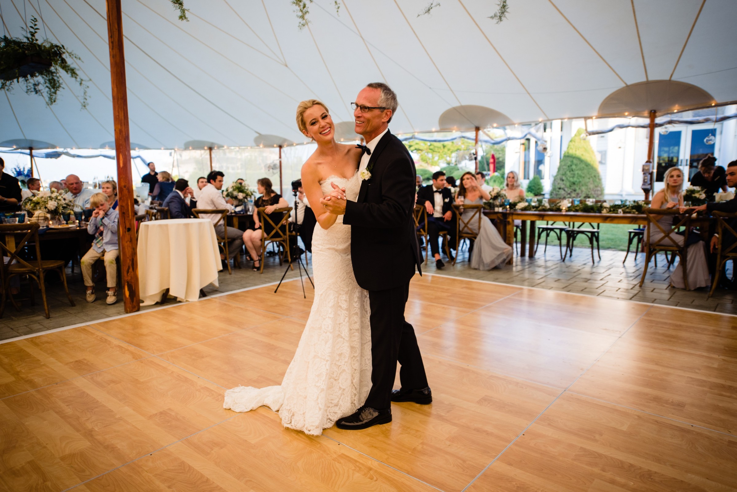 Bride dancing with her father under a white tent at elegant Wentworth by the Sea wedding.