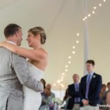 Bride and groom share first dance under string lights at Pelham House wedding in Dennis Port.