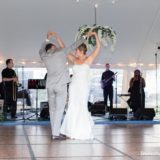 Bride and groom share their first dance under a white tent at Pelham House wedding.