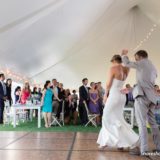 Bride and groom share first dance under glowing tent at Pelham House wedding in Dennis Port.