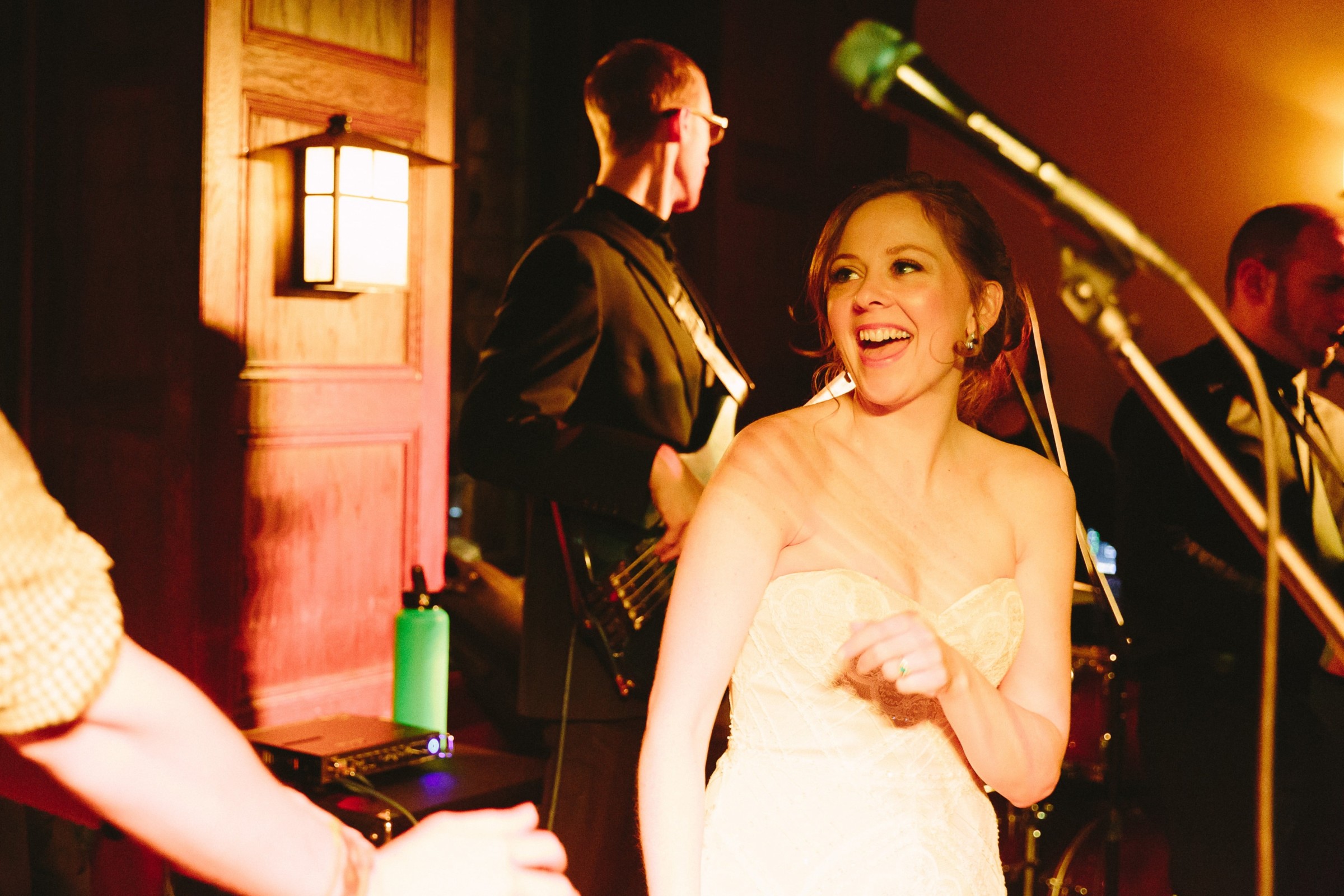 Bride laughing and dancing under warm golden light at Willowdale Estate wedding in Ipswich, Massachusetts.