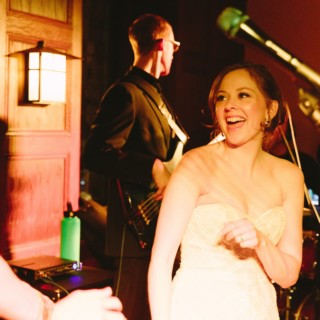Bride laughing and dancing under warm golden light at Willowdale Estate wedding in Ipswich, Massachusetts.