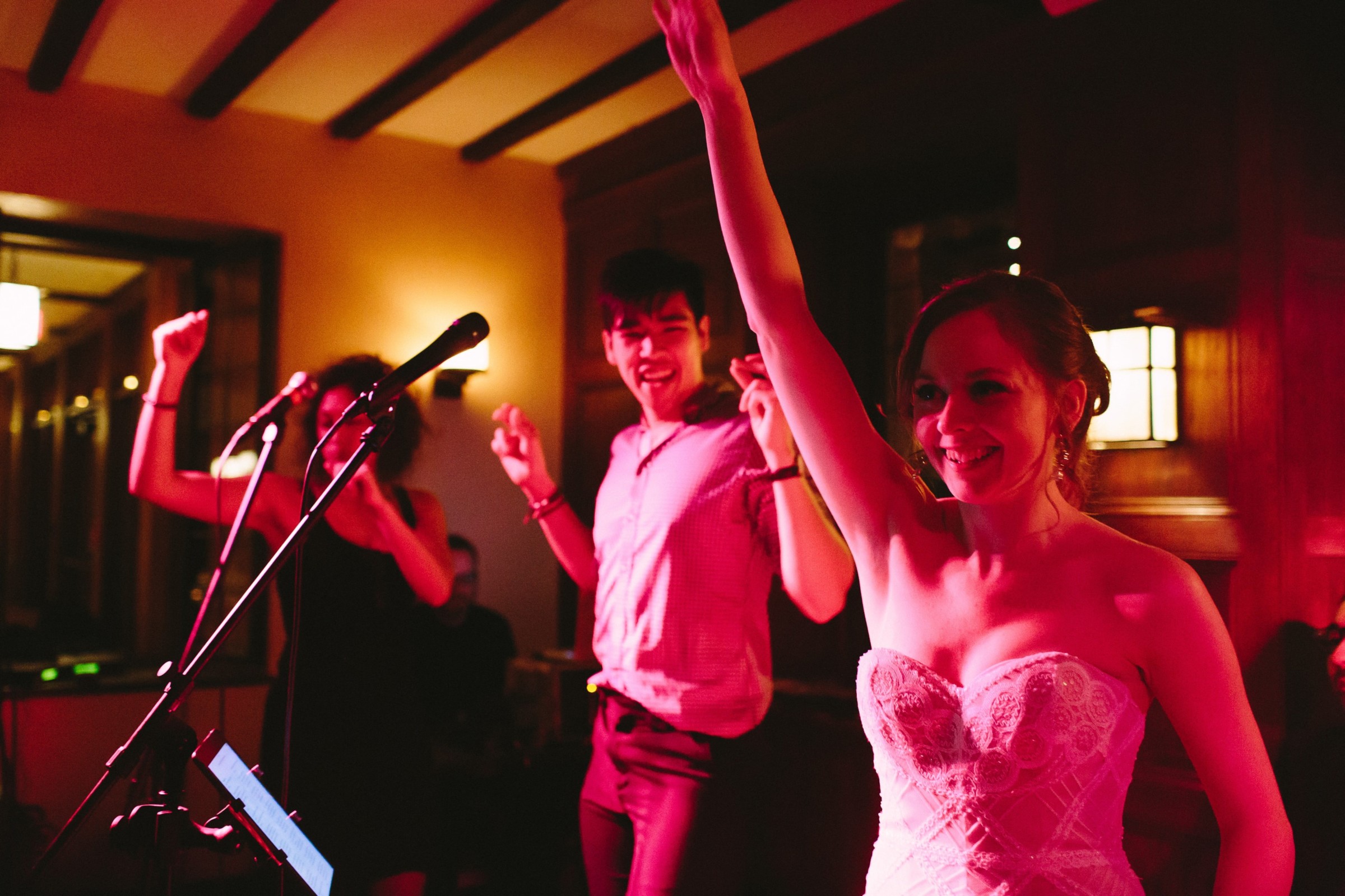 Bride celebrating with guests under warm lights at Willowdale Estate wedding in Ipswich, Massachusetts.