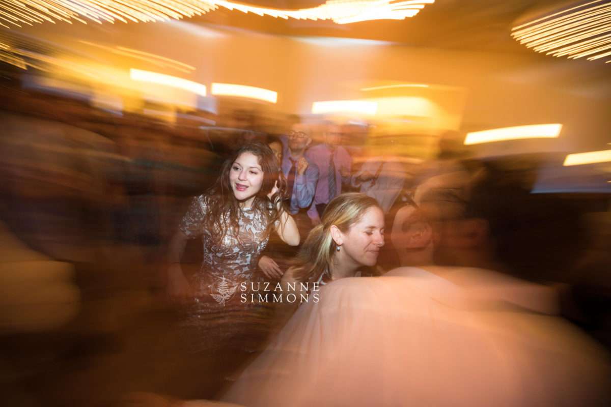 Joyful wedding dance at Ocean Gateway Portland with vibrant lights and lively celebration atmosphere.