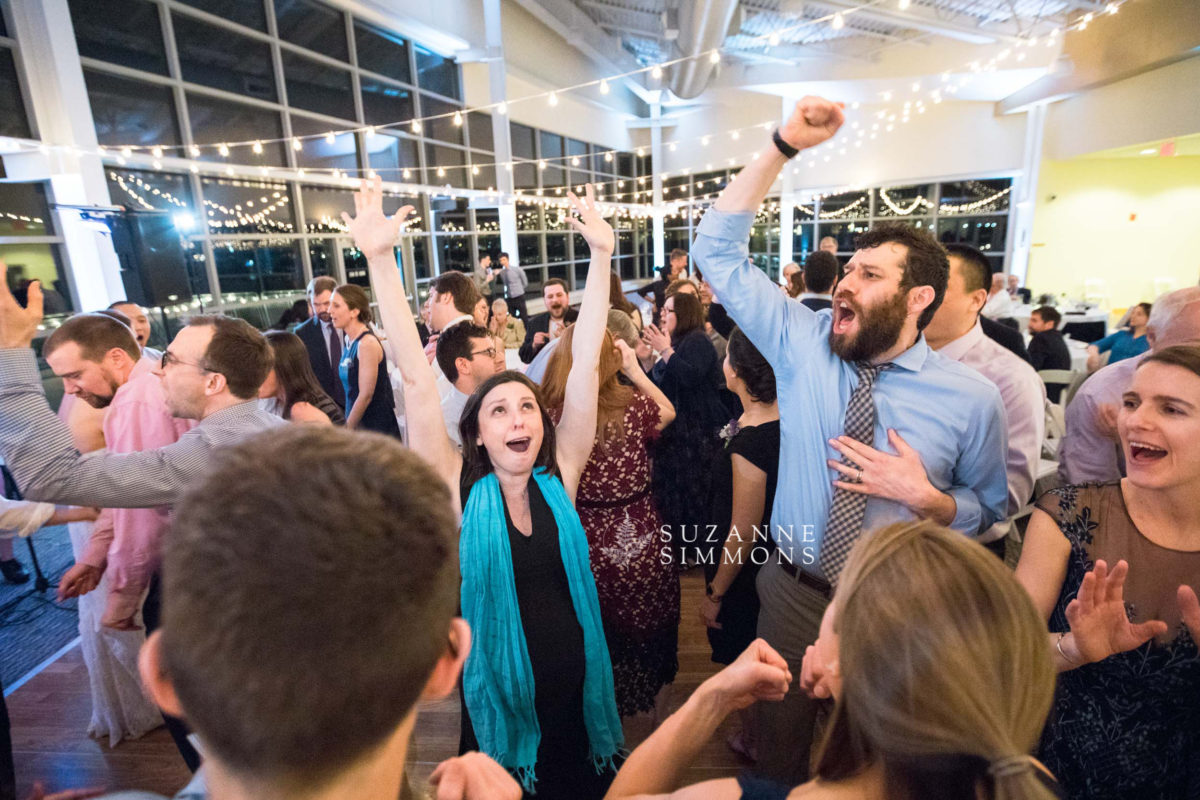 Guests dancing and celebrating joyfully at an Ocean Gateway wedding in Portland, Maine.