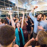 Guests dancing and celebrating joyfully at an Ocean Gateway wedding in Portland, Maine.