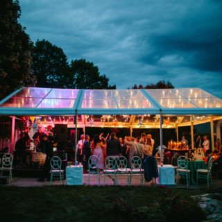 Elegant outdoor wedding reception under string lights at dusk in South Freeport, Maine.