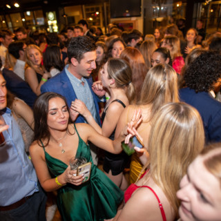 Young adults dancing and celebrating at a lively Dartmouth College party in Lebanon, New Hampshire.