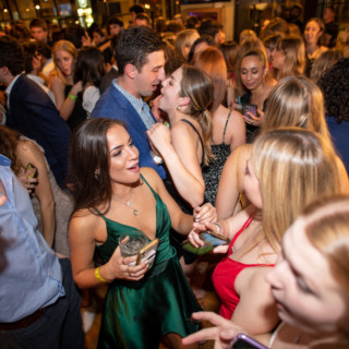 Dartmouth College students celebrating at a lively indoor party in Lebanon, New Hampshire.