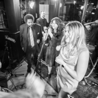 Smiling woman dancing to live band at Dartmouth College celebration in Lebanon, New Hampshire.