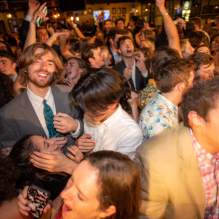 Dartmouth College students celebrating at a lively indoor party in Lebanon, New Hampshire.