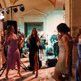 Guests dancing joyfully at an elegant Aldrich Mansion wedding reception in Warwick, Rhode Island.