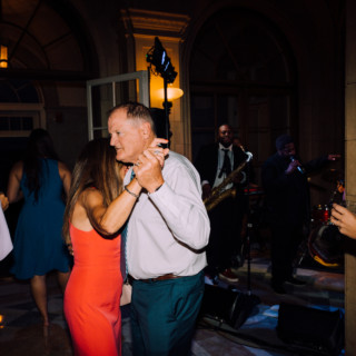 Couple dancing at elegant Aldrich Mansion wedding reception with live band and warm lighting.