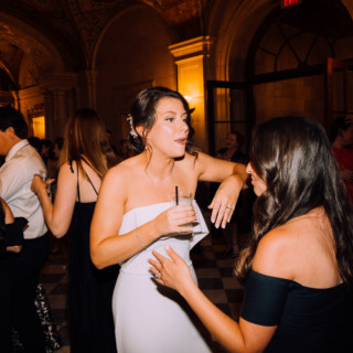 Bride and guest chatting during elegant Aldrich Mansion wedding reception in Warwick, Rhode Island.