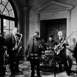 Black and white jazz band performing live in an elegant historic venue with soulful energy.