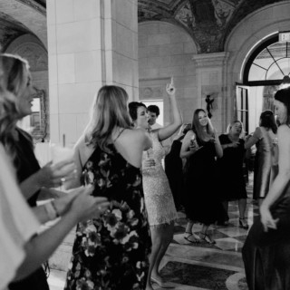 Guests dancing and celebrating in the grand black and white ballroom of Aldrich Mansion in Rhode Island.