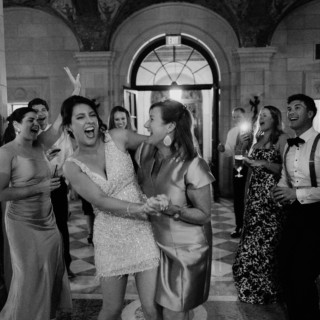 Elegant guests laughing and dancing at a joyful Aldrich Mansion wedding in Warwick, Rhode Island.