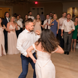 Couple dancing joyfully at Beauport Hotel wedding in Gloucester surrounded by smiling guests.