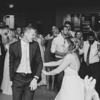 Bride and groom dancing joyfully with guests at a lively Beauport Hotel wedding in Gloucester.