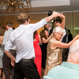 Guests of all ages dancing joyfully at a Beauport wedding in Gloucester, Massachusetts.