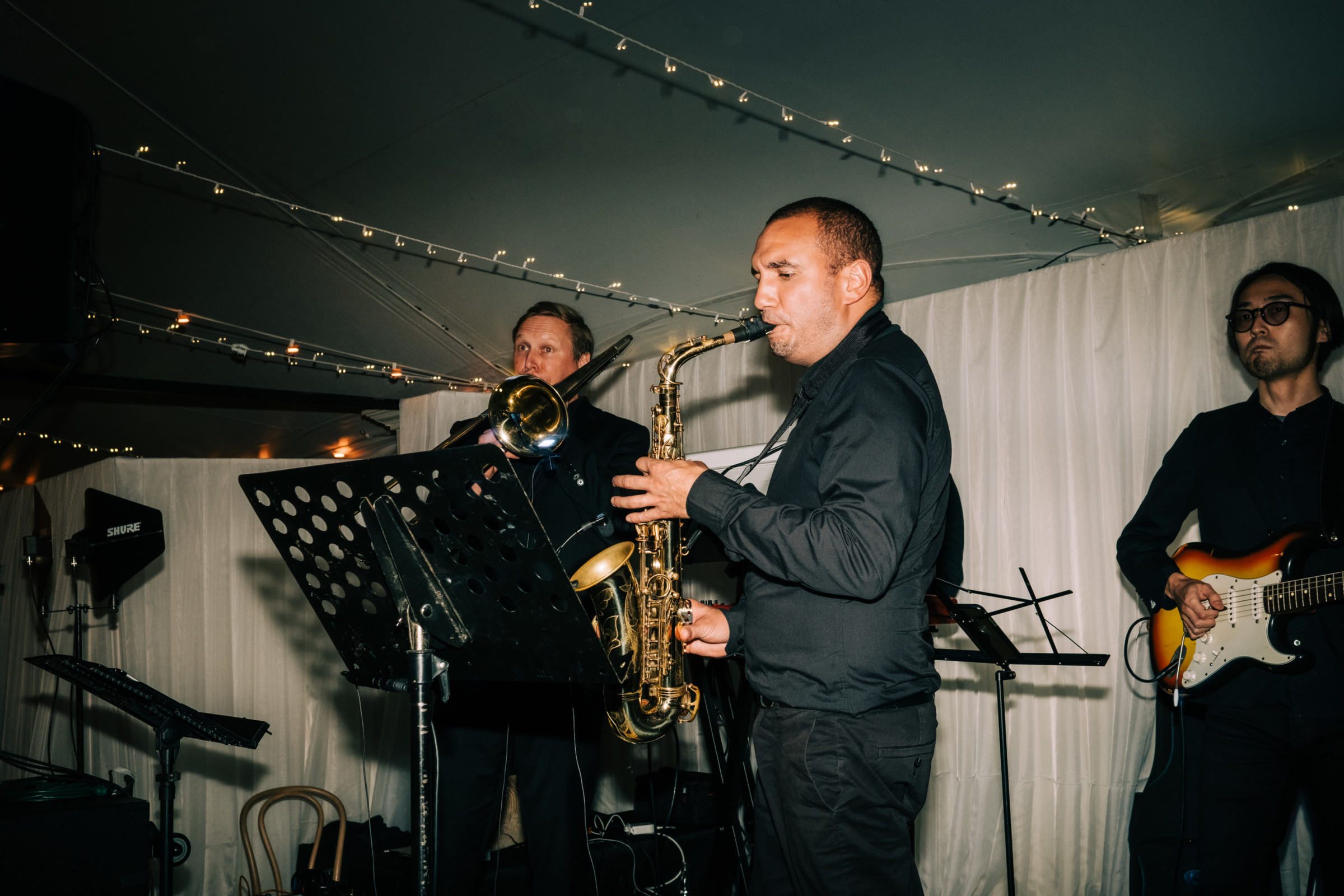 Jazz trio performing indoors under warm lighting at an elegant Manchester, Vermont wedding.