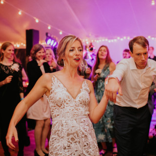 Bride and groom dancing joyfully at Toad Hill Farm wedding in Franconia, New Hampshire.
