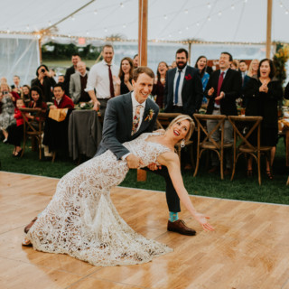 Bride and groom share a joyful first dance under glowing tent at Toad Hill Farm wedding.