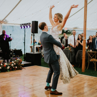 Bride and groom’s joyful first dance under string lights at Toad Hill Farm wedding, Franconia NH.