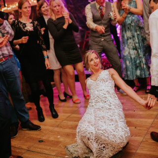 Bride and groom share joyful dance surrounded by cheering guests at Toad Hill Farm wedding.