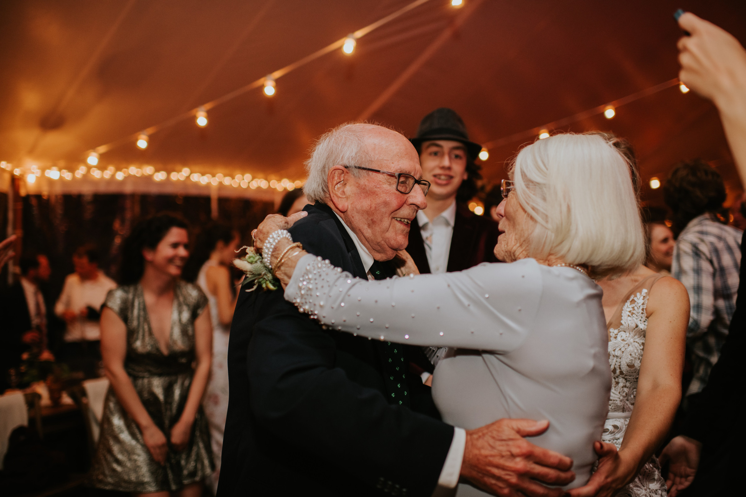 Elderly couple dancing joyfully at Toad Hill Farm wedding in Franconia, New Hampshire.