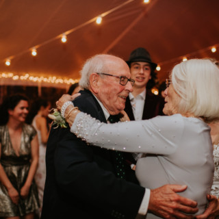 Elderly couple dancing joyfully at Toad Hill Farm wedding in Franconia, New Hampshire.