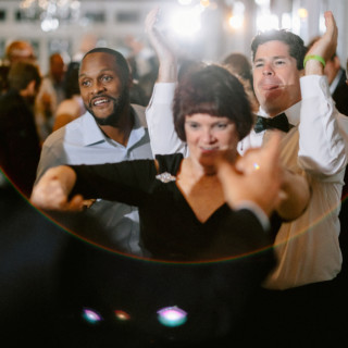 Guests dancing joyfully at a lively wedding reception at Wychmere Beach Club in Harwich Port.