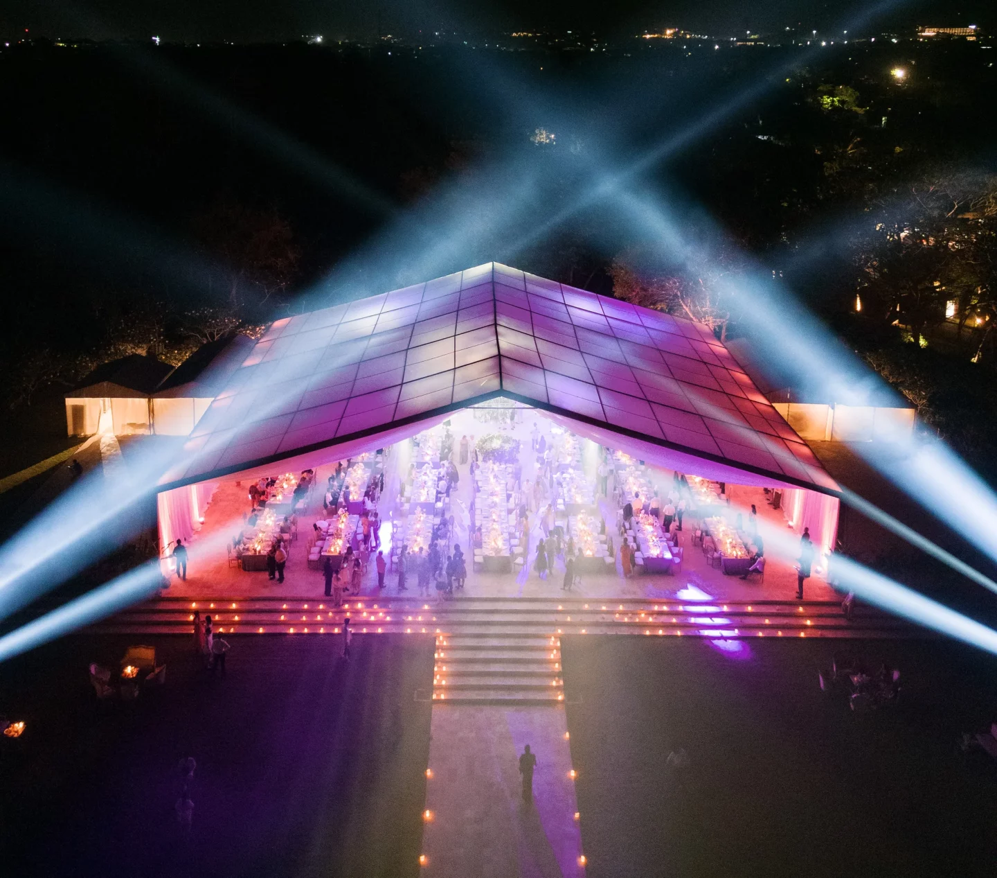 Bride and groom walking joyfully through tropical garden at Bali wedding celebration.