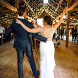 Bride and groom celebrate their rustic barn wedding at Cunningham Farm in New Gloucester, Maine.