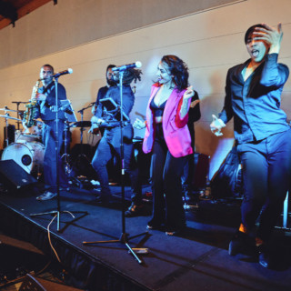 Energetic live band performing indoors at a wedding celebration in Ogunquit, Maine.