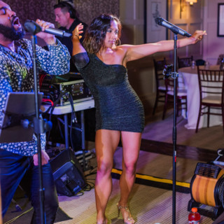 Live music duo performing at elegant indoor venue with warm lighting and sophisticated decor.