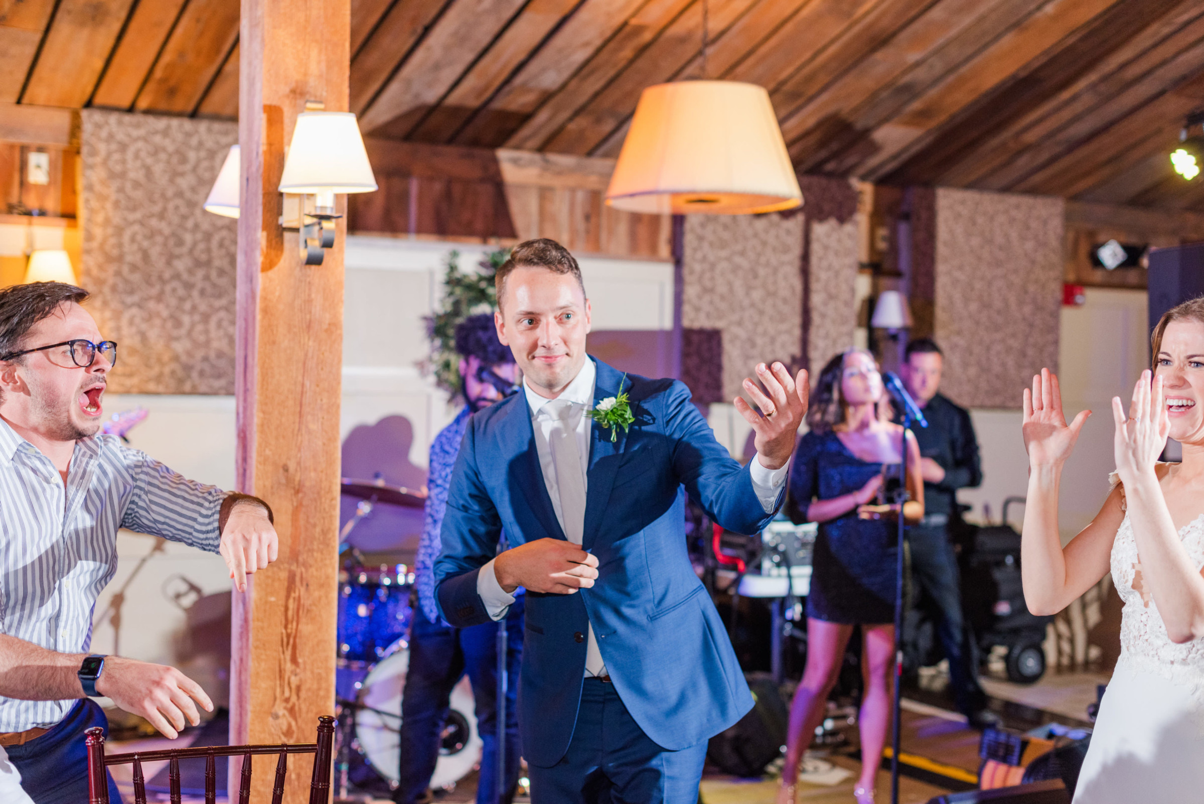 Bride and groom dancing joyfully during rustic wedding reception at Gibbet Hill in Groton, Massachusetts.