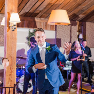 Bride and groom dancing joyfully during rustic wedding reception at Gibbet Hill in Groton, Massachusetts.