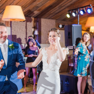Bride and groom joyfully dancing at Gibbet Hill wedding in Groton, Massachusetts.