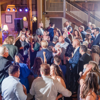 Guests dancing and celebrating at a joyful Gibbet Hill Barn wedding reception in Groton, Massachusetts.