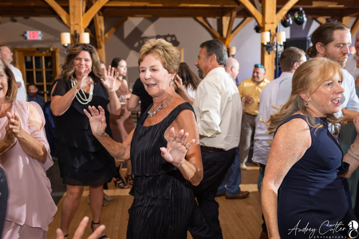 Guests dancing and celebrating at a rustic Harrington Farm wedding reception in Princeton, Massachusetts.