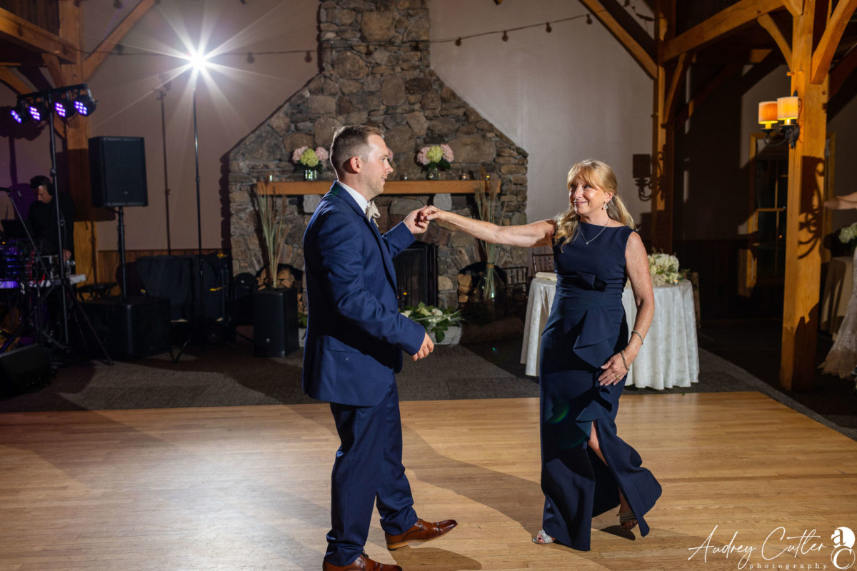 Mother and son share a joyful dance at a rustic Harrington Farm wedding in Princeton, MA.