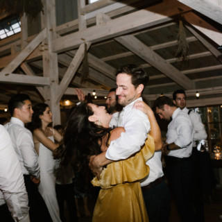 Couple sharing a joyful first dance at a rustic barn wedding in Wiscasset, Maine.