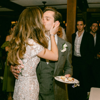 Bride and groom share a romantic kiss during their wedding reception at Migis Lodge, Maine.