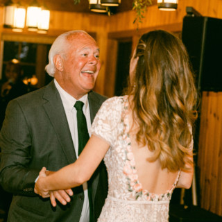 Father-daughter dance at Migis Lodge wedding in South Casco, Maine, with warm golden lighting.
