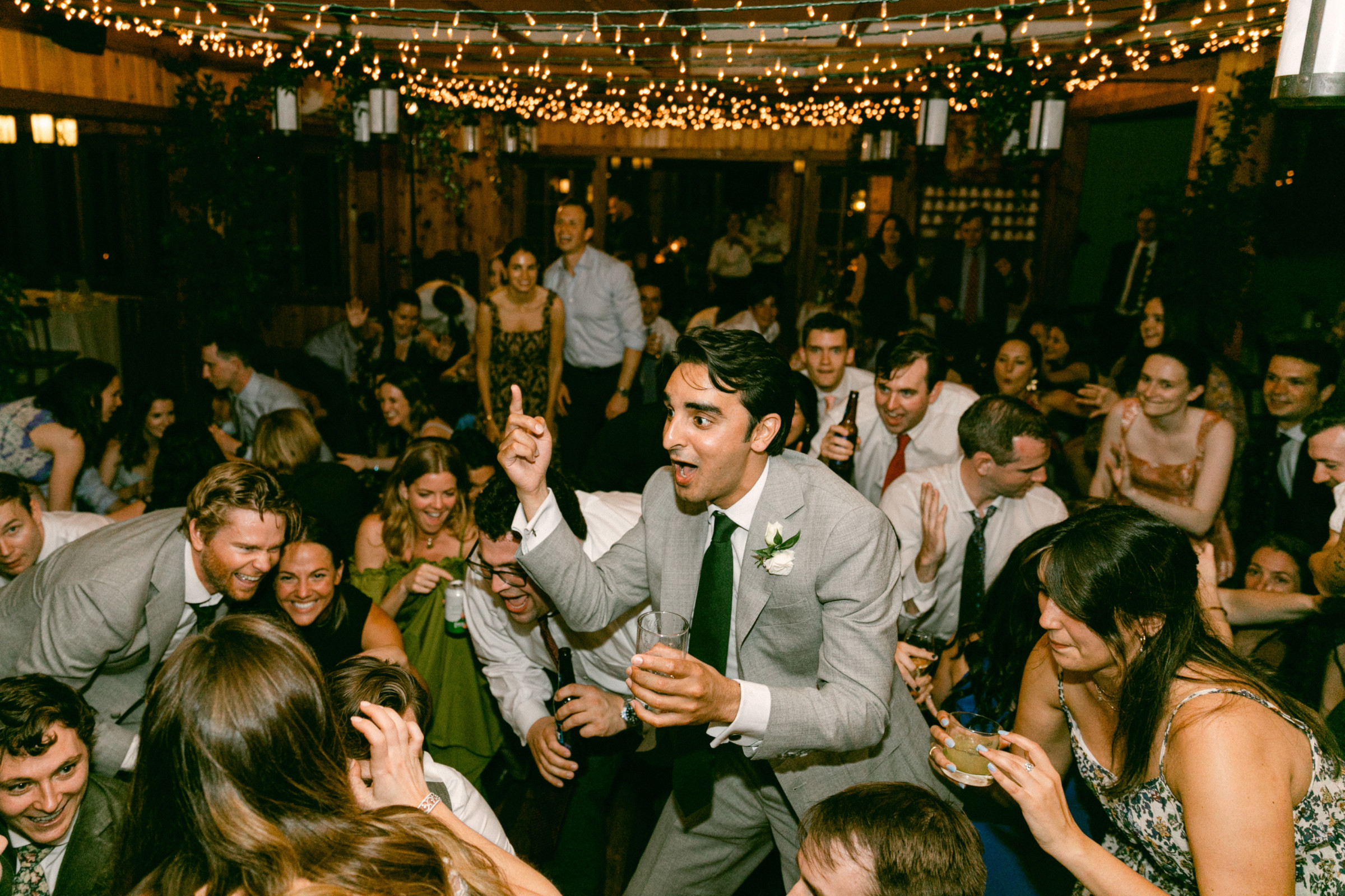 Groom leading joyful wedding dance at Migis Lodge in South Casco, Maine.