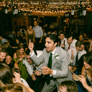 Groom leading joyful wedding dance at Migis Lodge in South Casco, Maine.