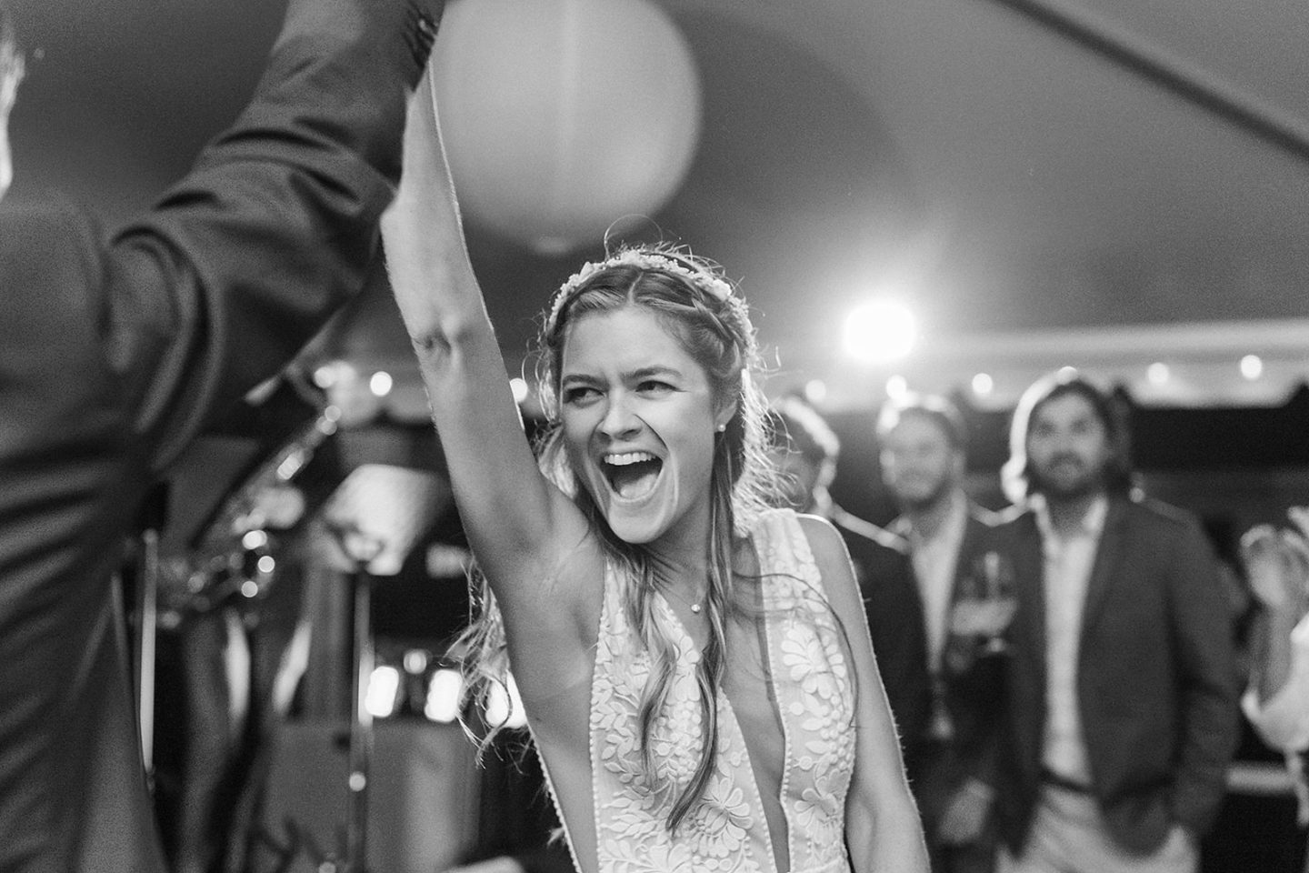 Energetic live band performance under a white wedding tent in Marblehead, Massachusetts.
