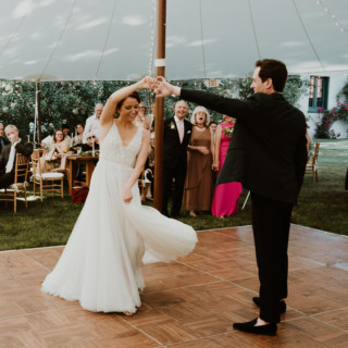 Bride and groom’s first dance under canopy lights at elegant outdoor wedding in Manchester, Vermont.