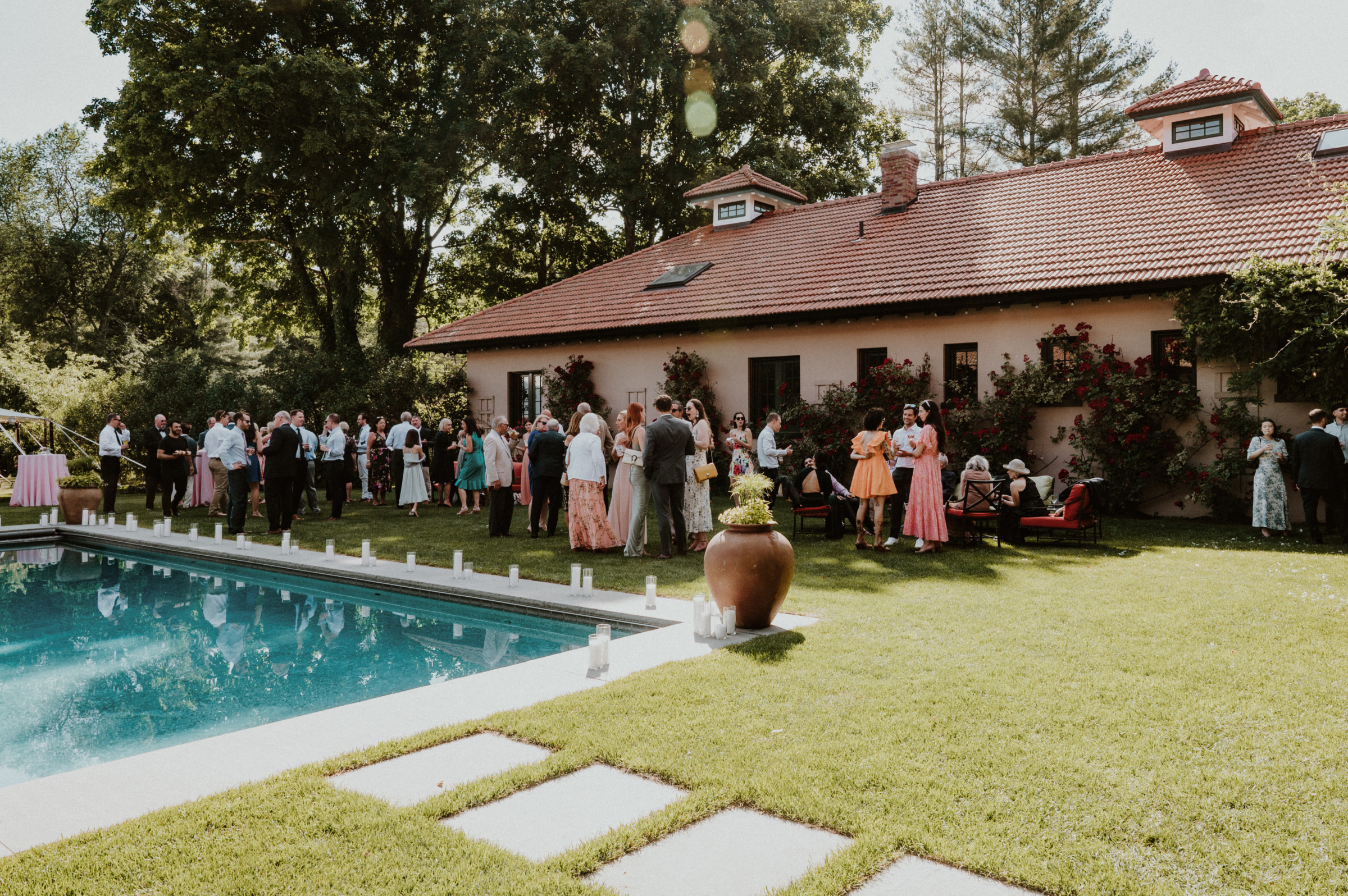 Guests celebrating by a pool at a charming garden estate in Manchester, Vermont.